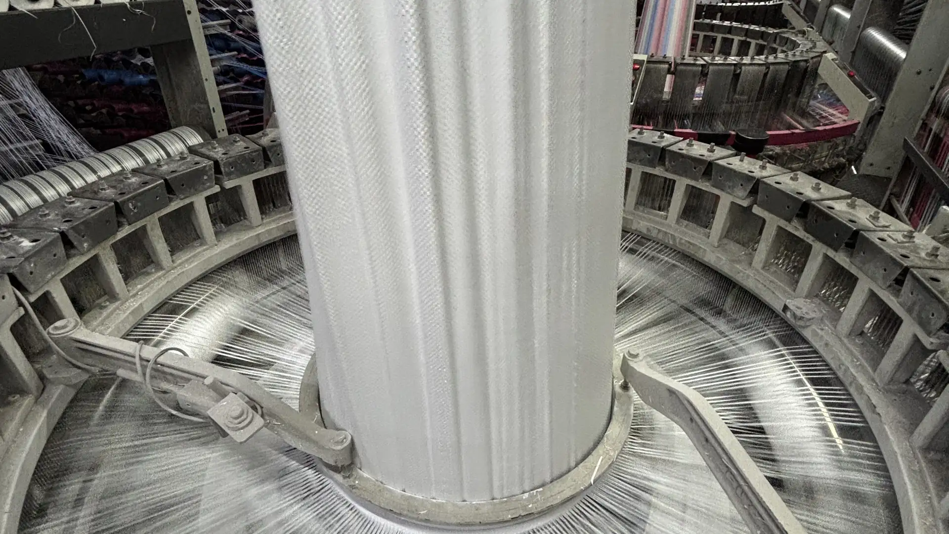 Weaving — Circular loom running plain white fabric