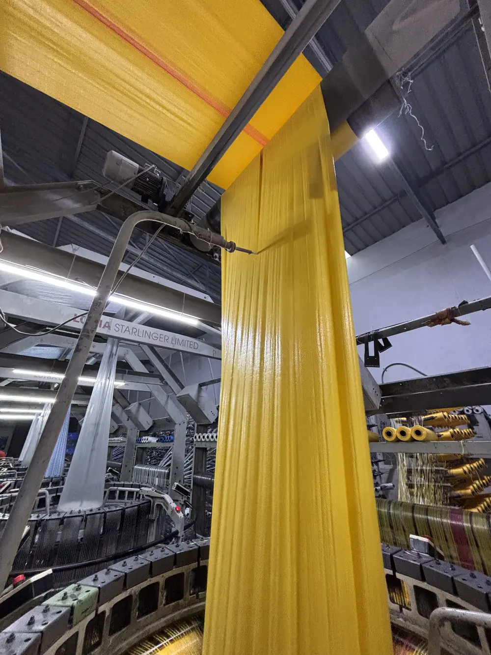 Weaving — Fabric leaving the loom ahead of the winder