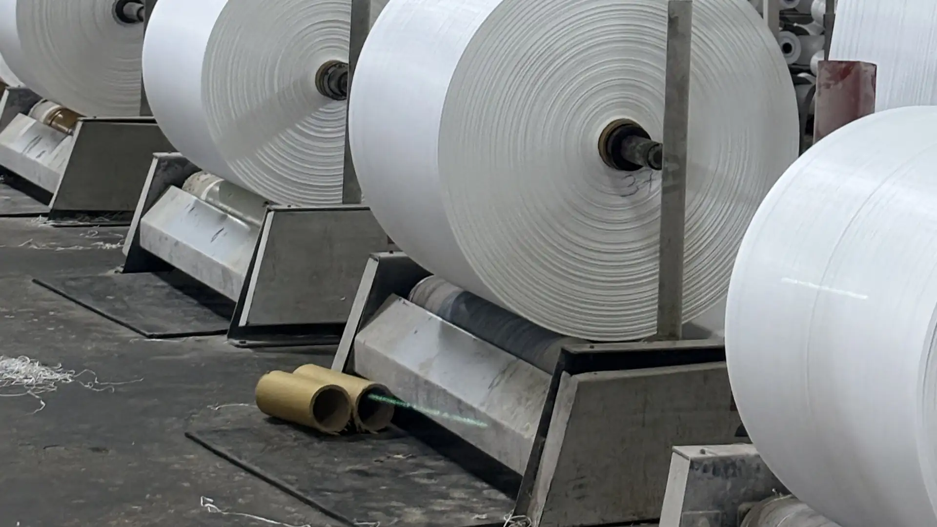 Rolls — Bulk white fabric rolls ready for conversion